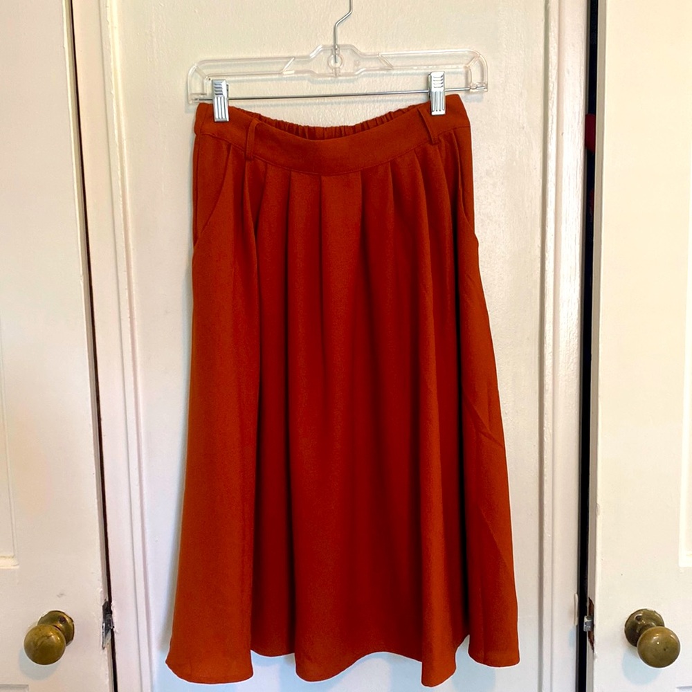Orange knee length flowy skirt from ModCloth